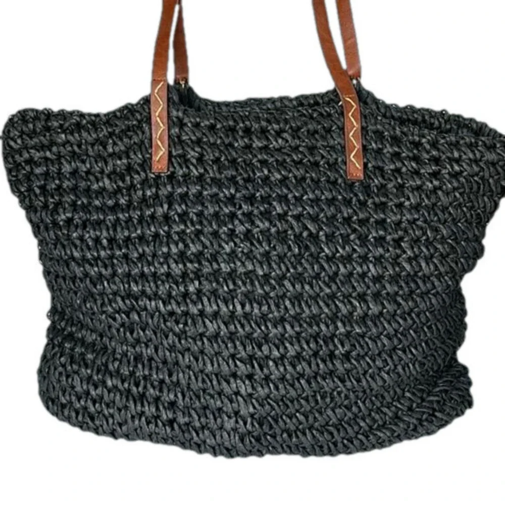 Kenneth Cole straw bag in back with tan straps